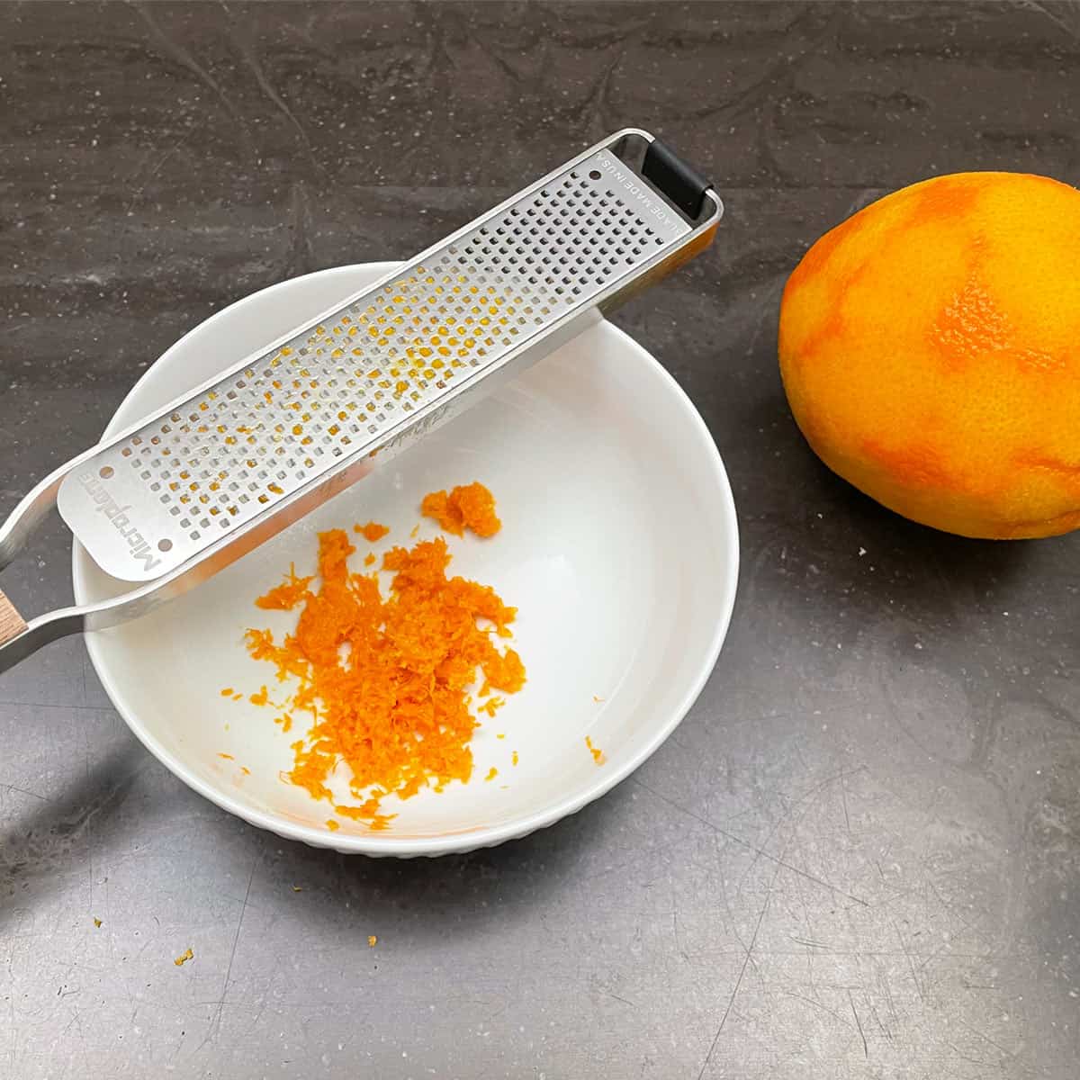 Zest from one orange in a bowl.