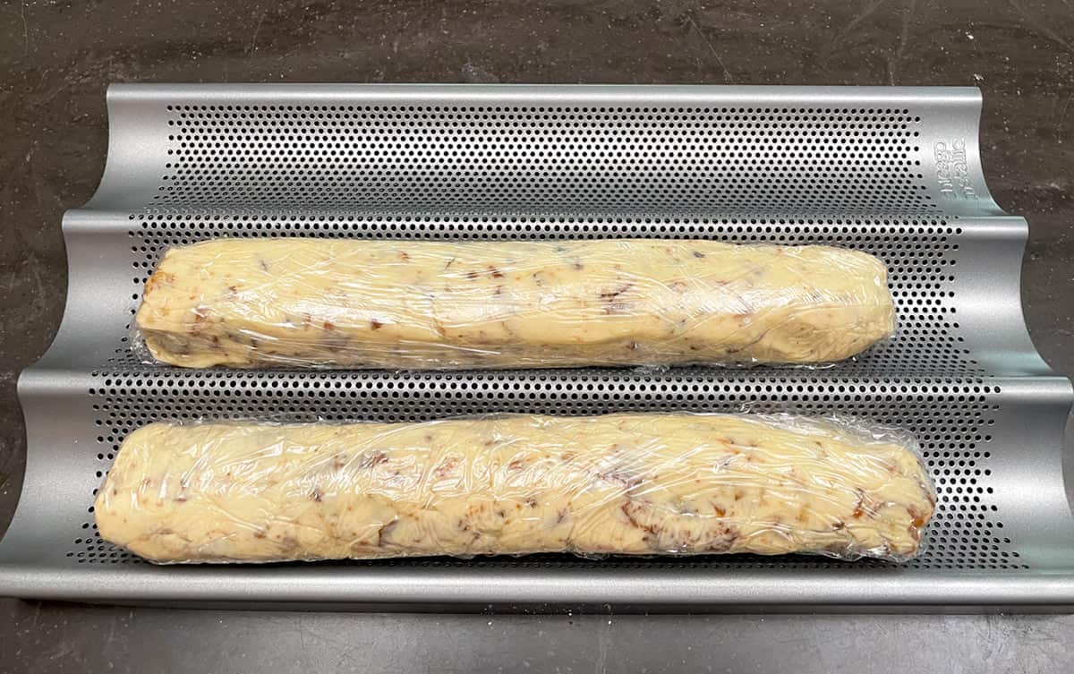 Two wrapped logs resting in a baguette pan ready for the fridge.