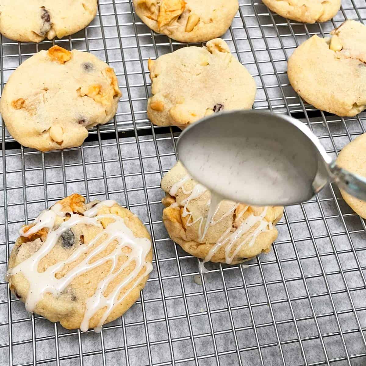 Using a spoon to add the A La Mode Glaze to the top of the Apple Pie A La Mode Cookies.
