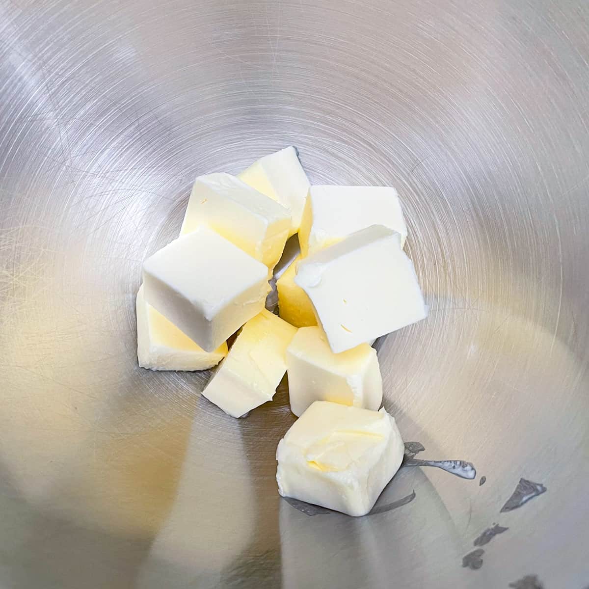 Cubed butter in a mixer bowl before creaming the butter.