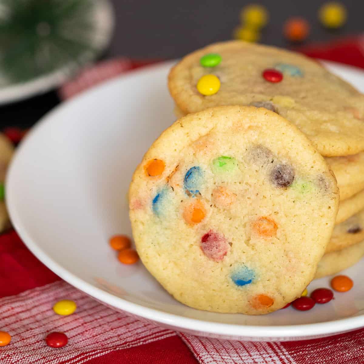 2021 New Year's cookie, on a white plate with colored mini M&M's all over the place.