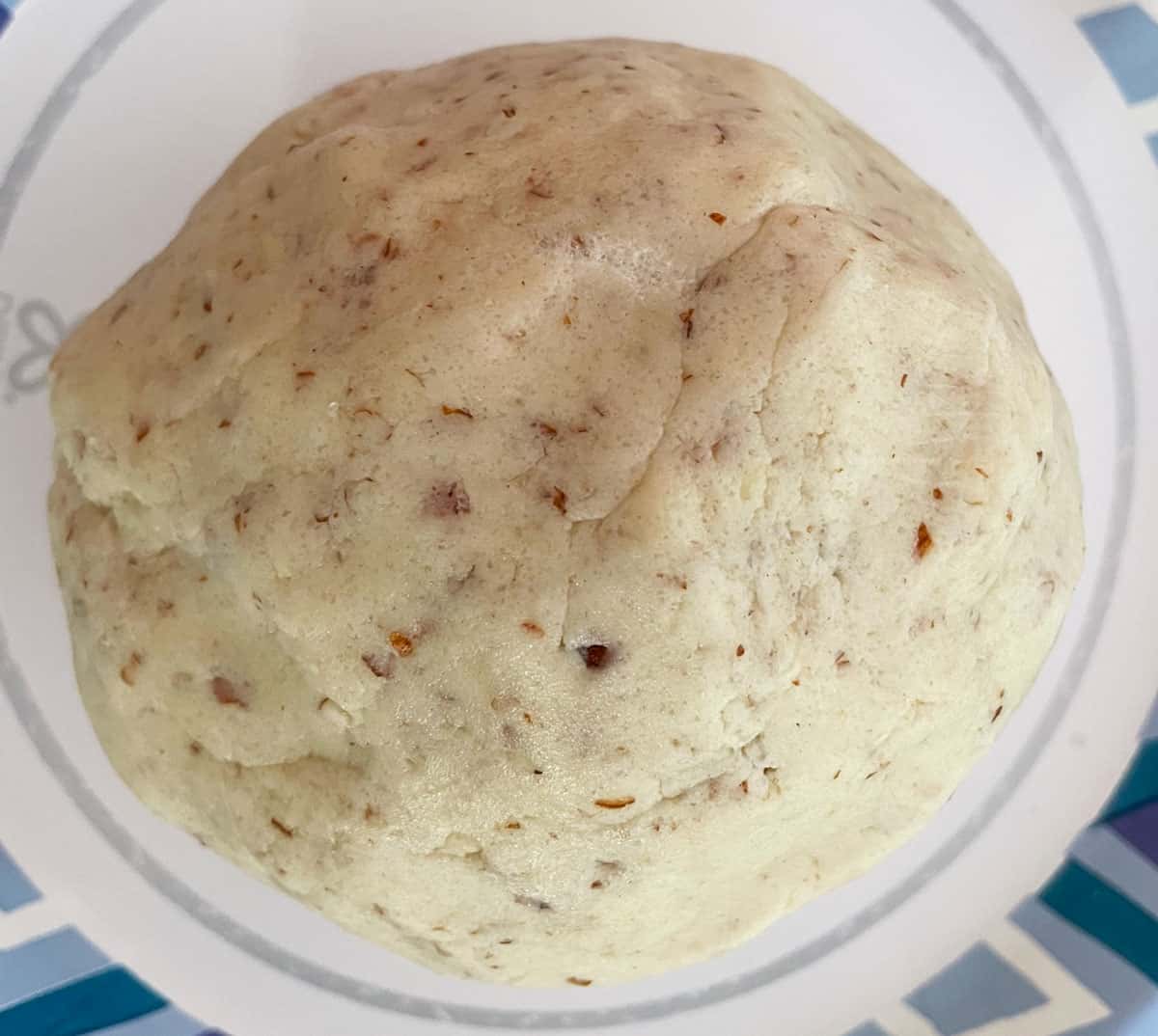 Almond Crescent cookie dough is molded into a ball after taking the dough out of the mixer bowl.