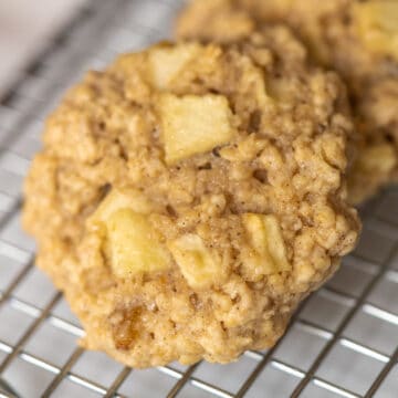 Apple raisin walnut oatmeal cookies finished on a wire rack.