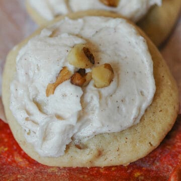 Applesauce and Walnut cookie with icing and chopped walnuts on top.