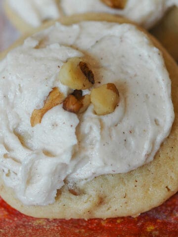 Applesauce and Walnut cookie with icing and chopped walnuts on top.