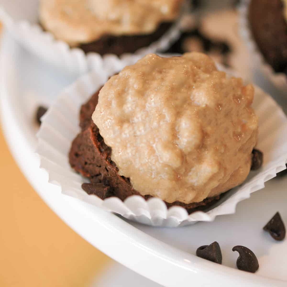 Chocolate with peanut butter cupcake cookies in a small cupcake wrapper on a white dish.