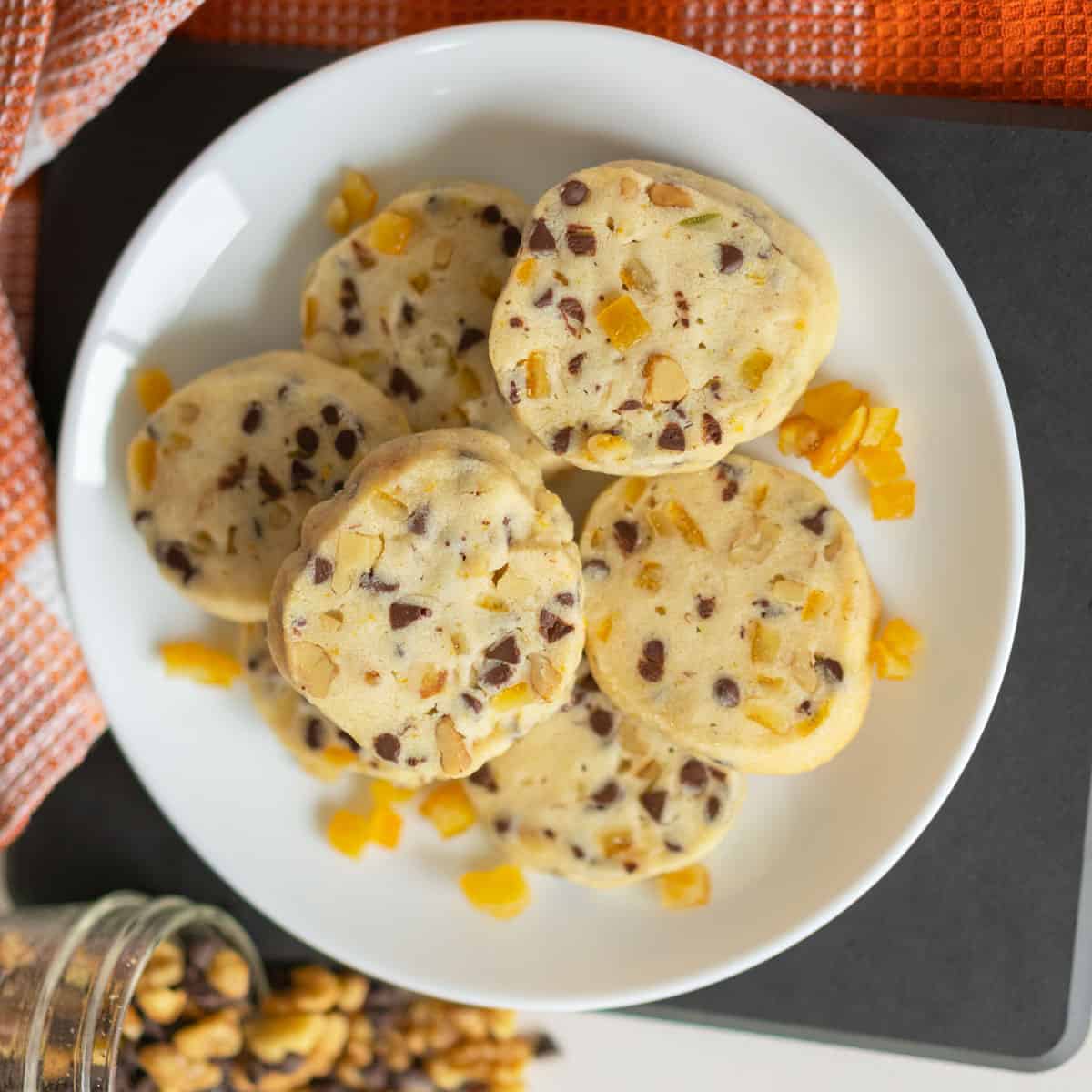 Baked Chocolate with Walnut and orange peel cookies displayed on a white plate.