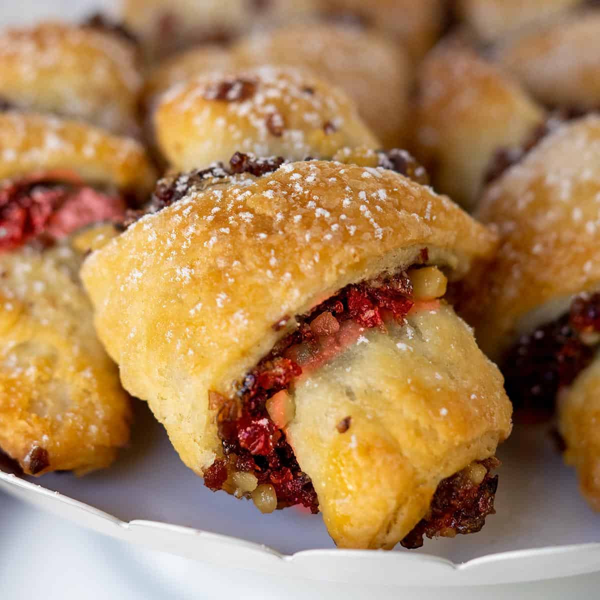 Close-up of a baked cranberry orange and walnut rugelach.
