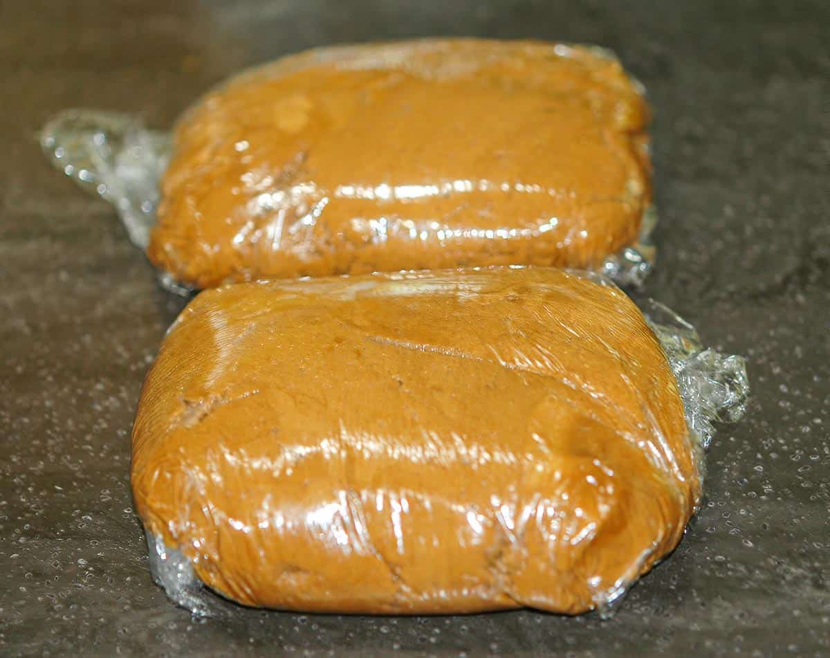 Gingerbread Crinkle cookie dough wrapped in plastic to go into the refrigerator.