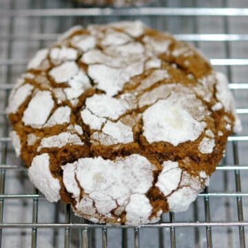 Gingerbread crinkle cookie finished and sitting on a wire rack.