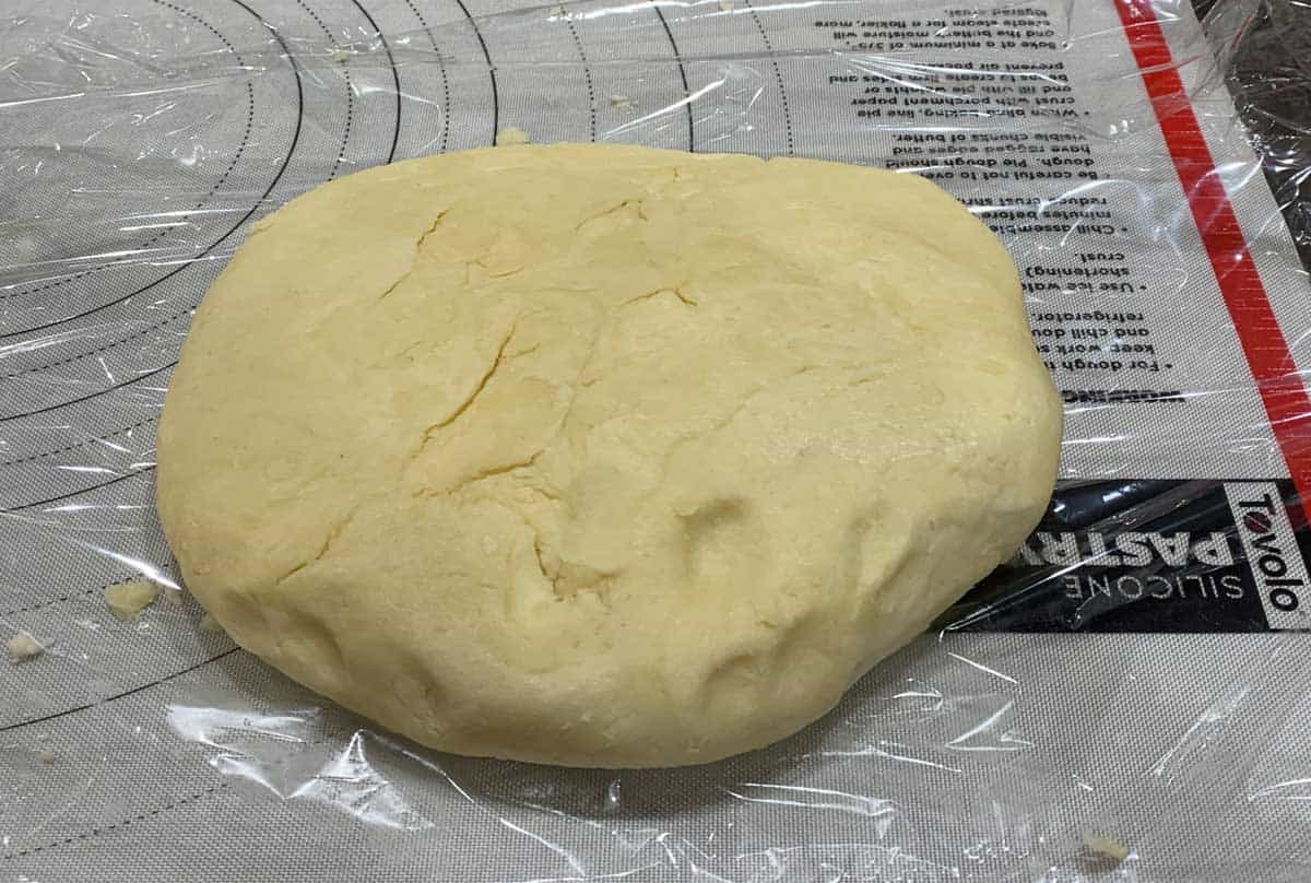 All the dough is pressed into an oval shape to be wrapped in plastic.