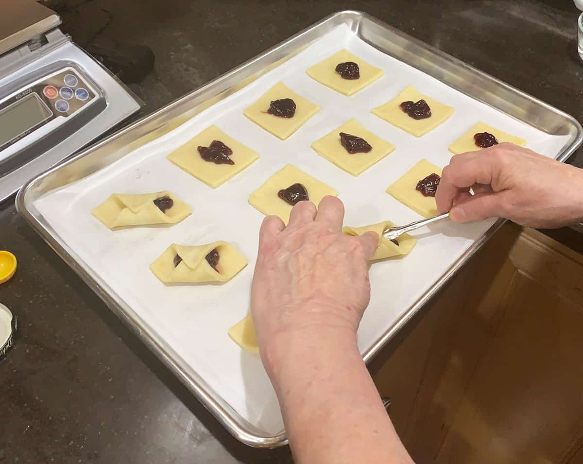 Showing how to fold and seal the kolache cookies.
