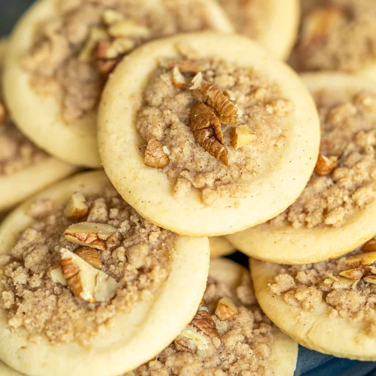A breakfast cookie with cinnamon and walnuts on top.