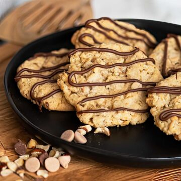 Caramel and Oats Cookies with Pecans on a black plate.