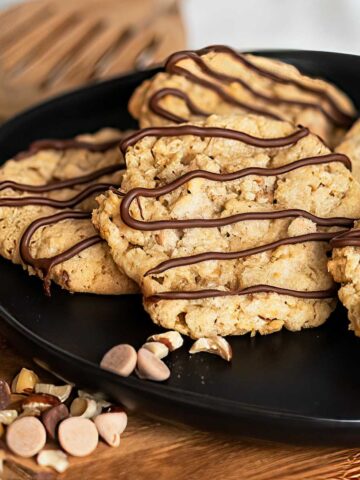 Caramel and Oats Cookies with Pecans on a black plate.