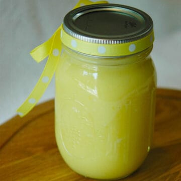 Jar of lemon curd with a ribbon tied around the lid.