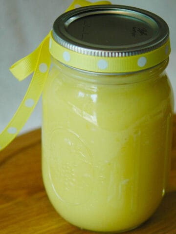Jar of lemon curd with a ribbon tied around the lid.