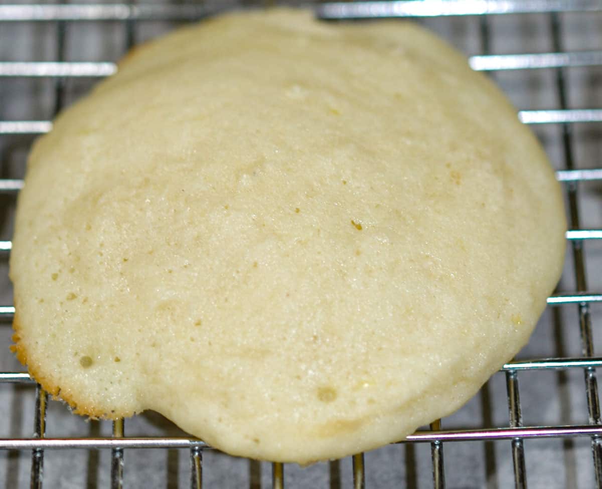 Lemon Ricotta cookie cooling on a wire rack.