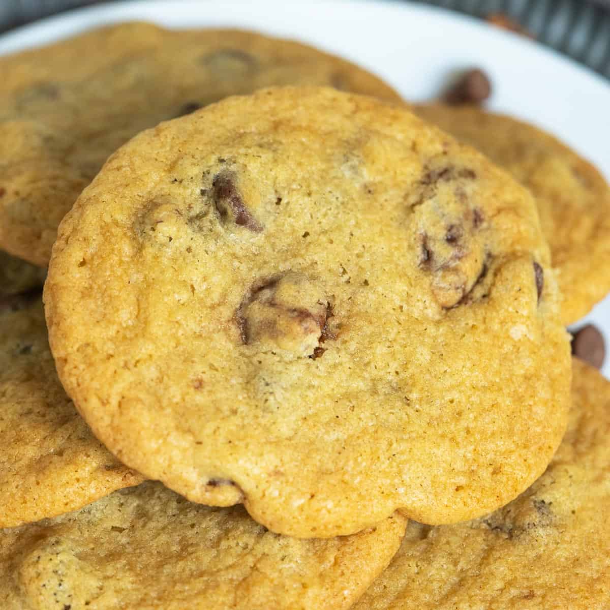 Finished chocolate chips and glazed pecans cookies on a white plate.