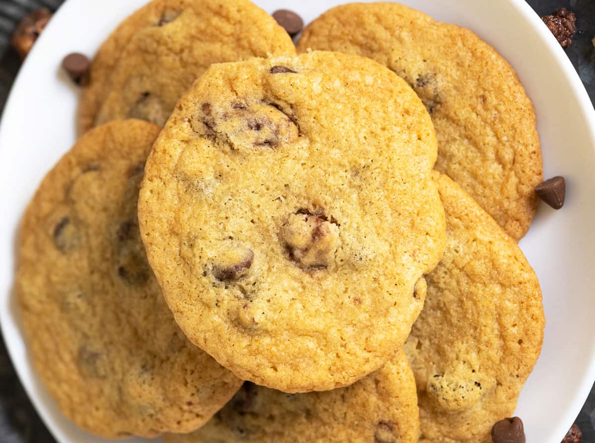 Finished chocolate chips and glazed pecans cookies on a white plate.