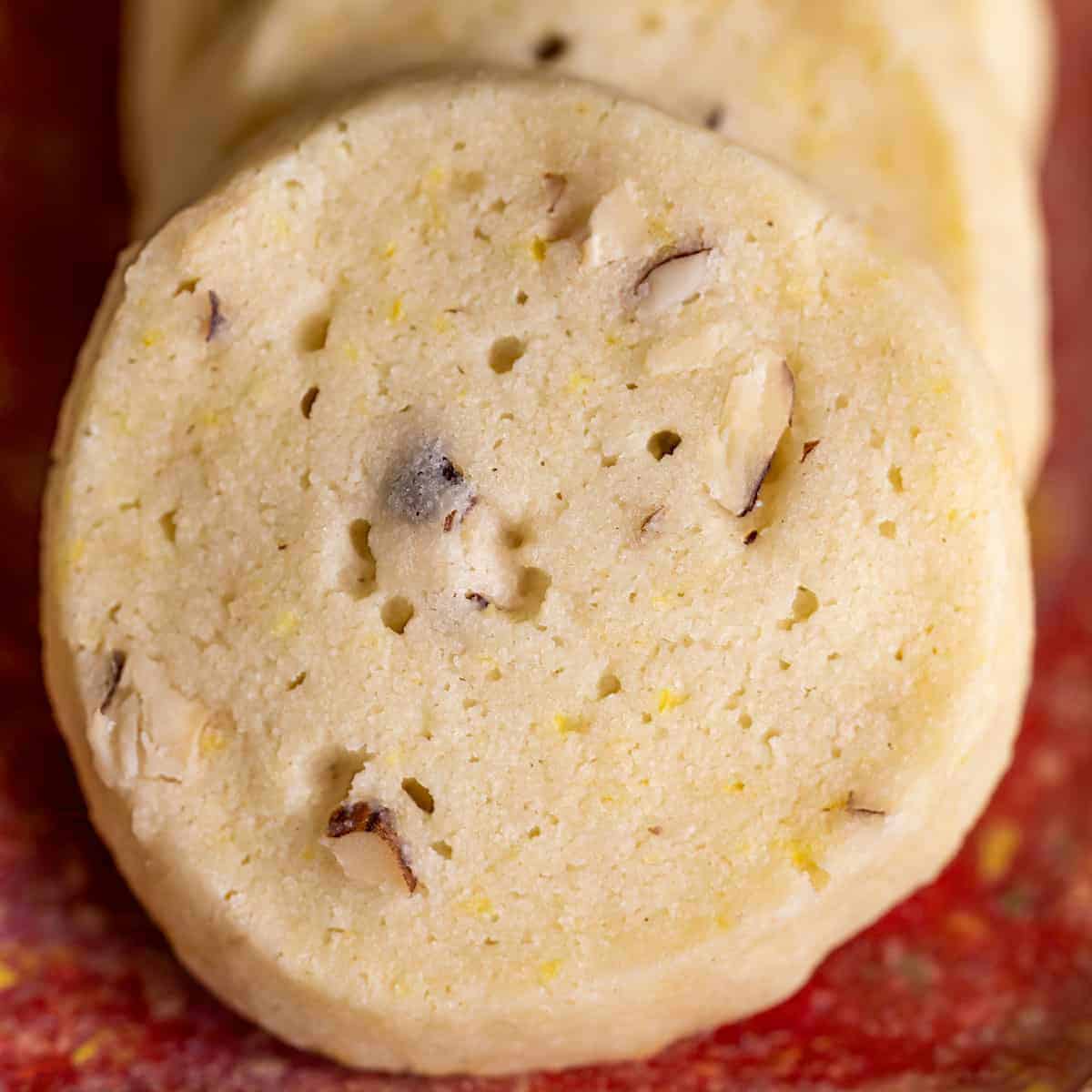 Lemon Ginger with Hazelnut Shortbread cookie on a red dish.