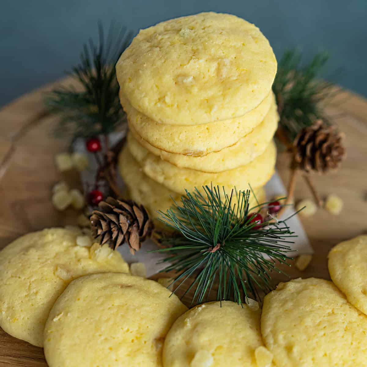 Lemon with a touch of Honey Cookies stacked with pine cone and pine branches around the base of cookies.