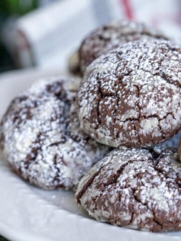 Mexican spicy chocolate crinkle cookies on a white plate ready to serve to guests.