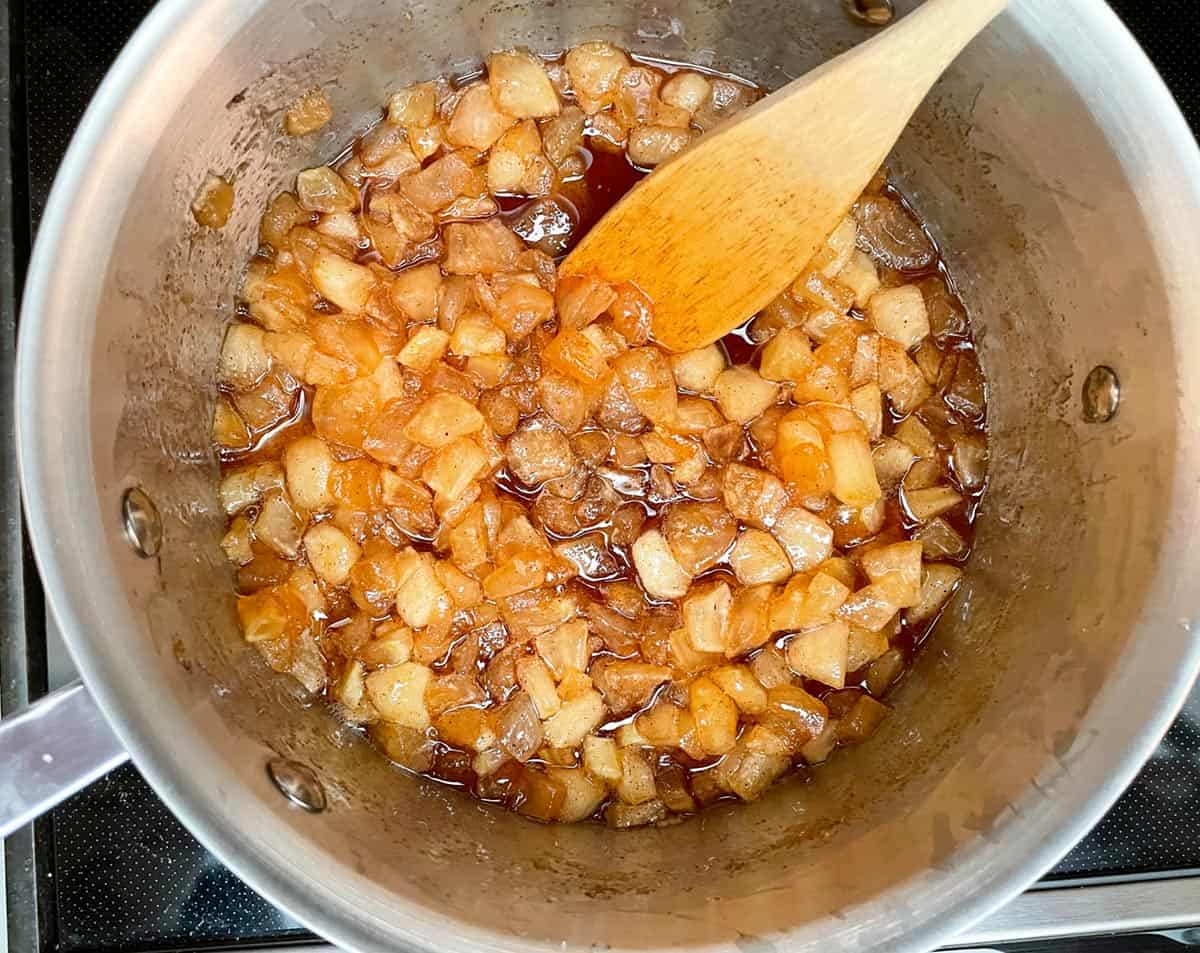 Chunky Apple Jam with syrupy liquid and apple totally infused with the apple pie spice.