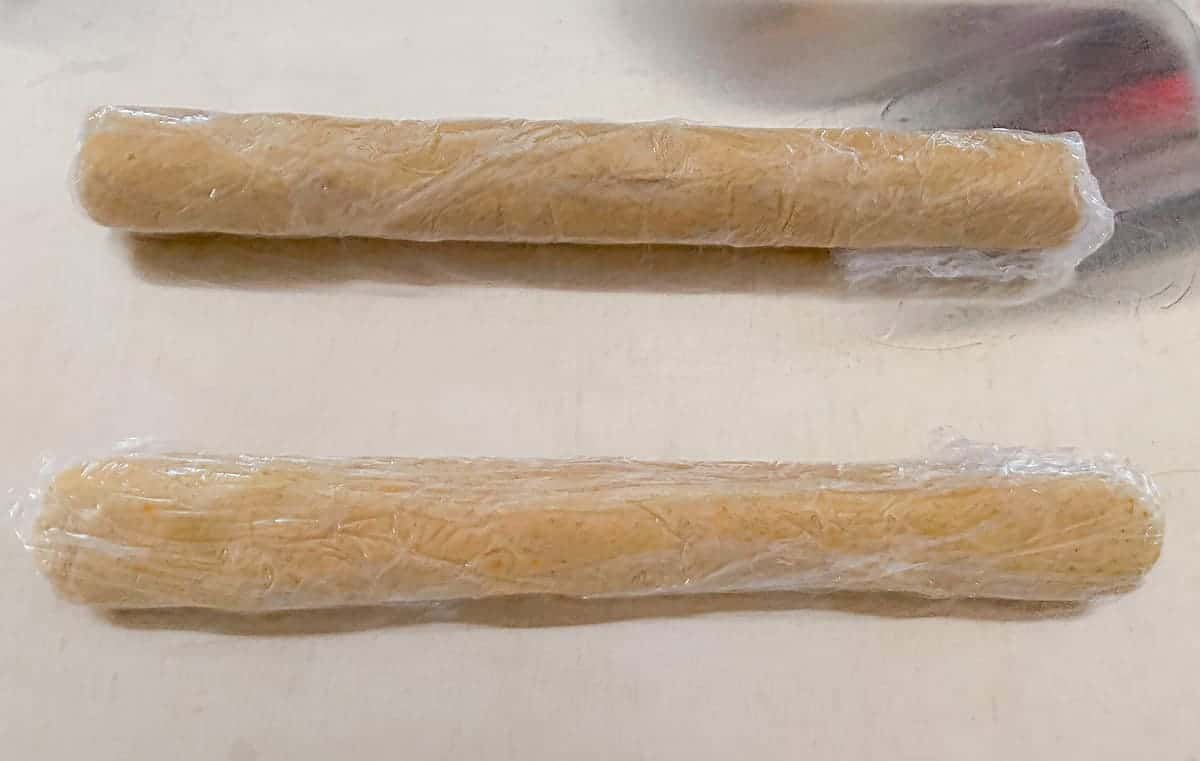 cardamom orange shortbread 2 rolls wrapped in plastic ready for the refrigerator.