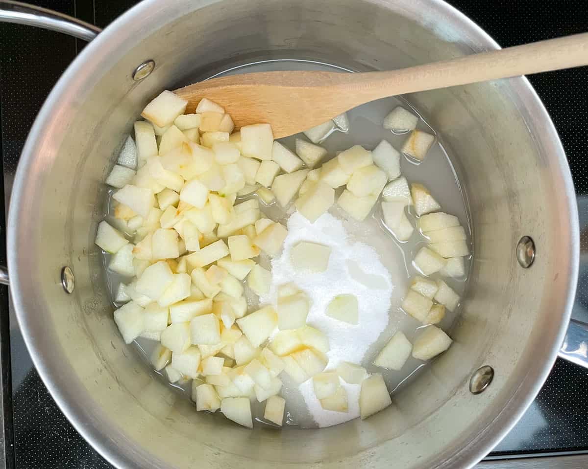 Sugar, water and diced apples into a pan to start the jam.