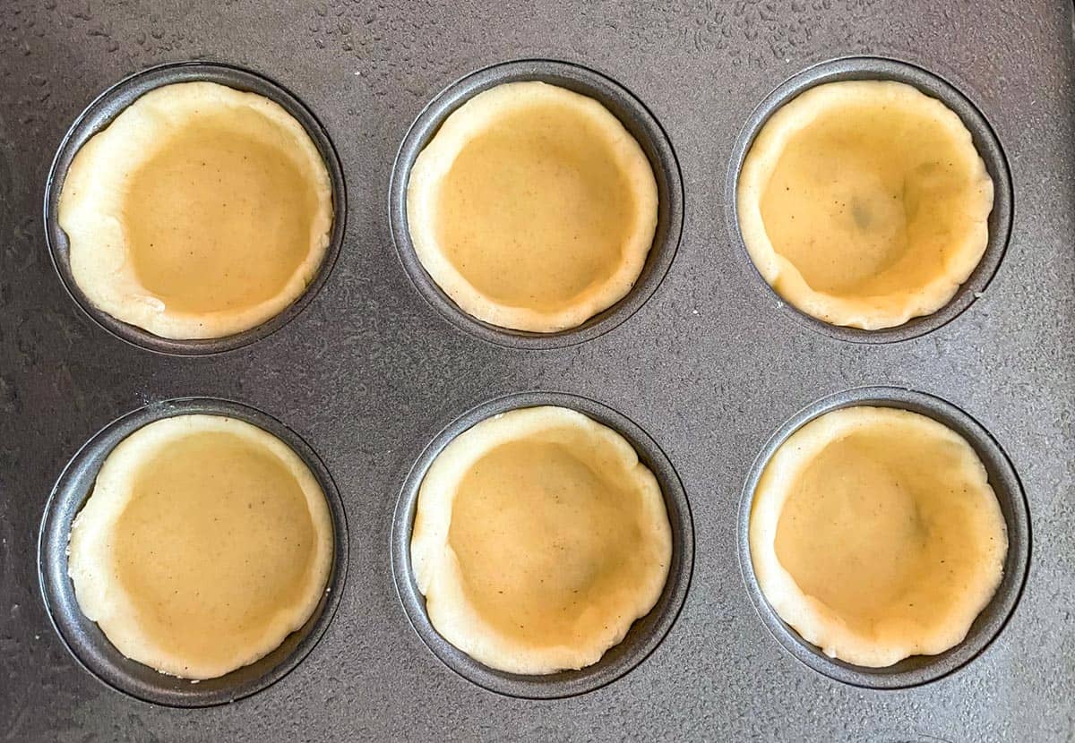 Six pre-baked cups in a mini cup pan pressed against the sides to fit.