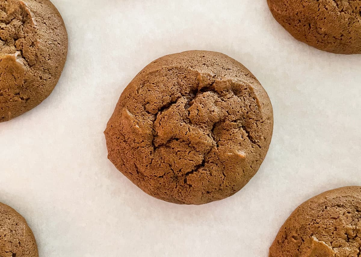 Finished molasses cookie resting on sheet pan before moving to cooling rack.