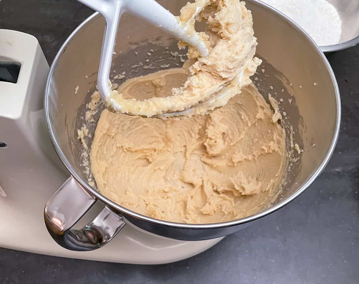 Creaming butter and sugars together with a stand mixer.
