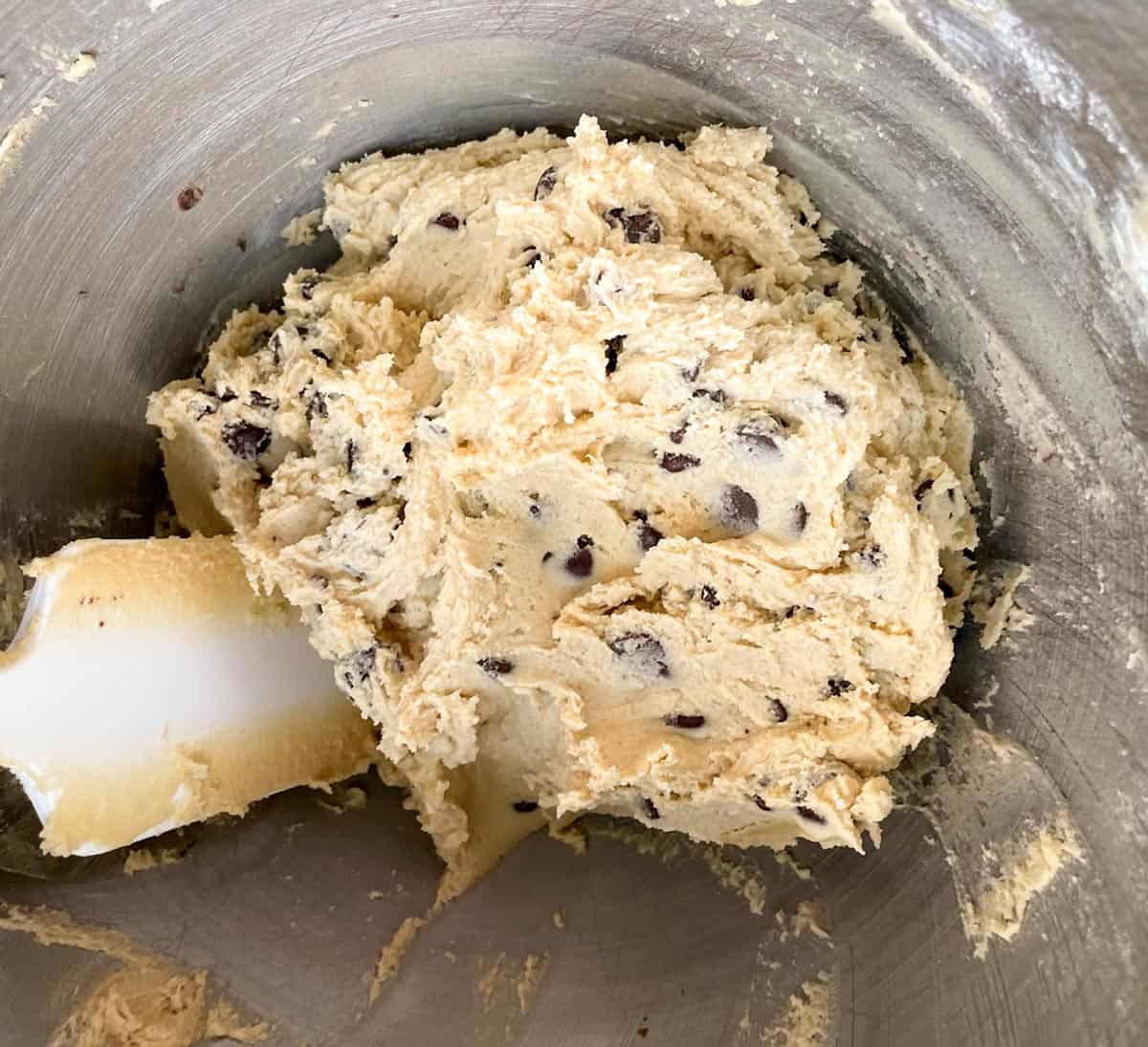 Chocolate Chip cookie dough in the mixer bowl. A perfect light brown color.