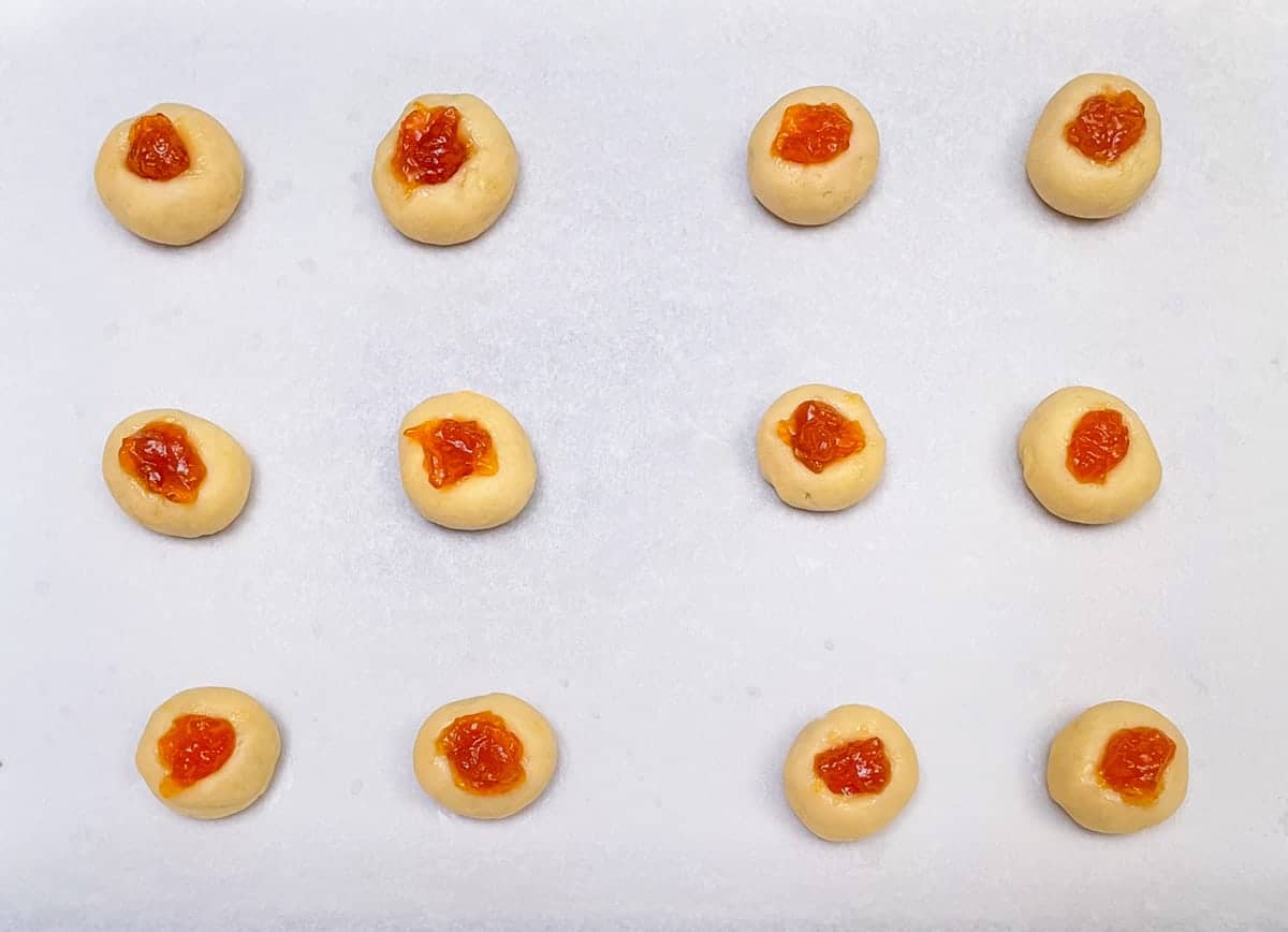 Cookies filled with apricot preserves and ready for the oven.