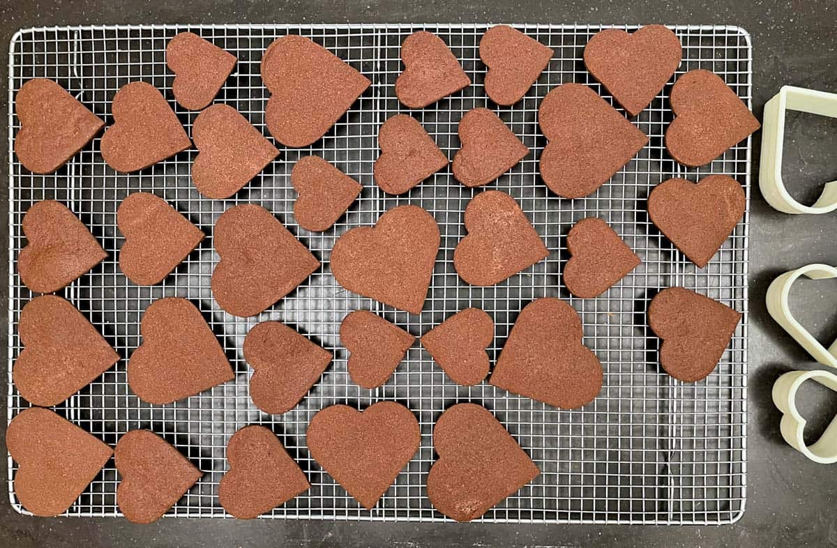 Chocolate heart cookies cooling on a rack.