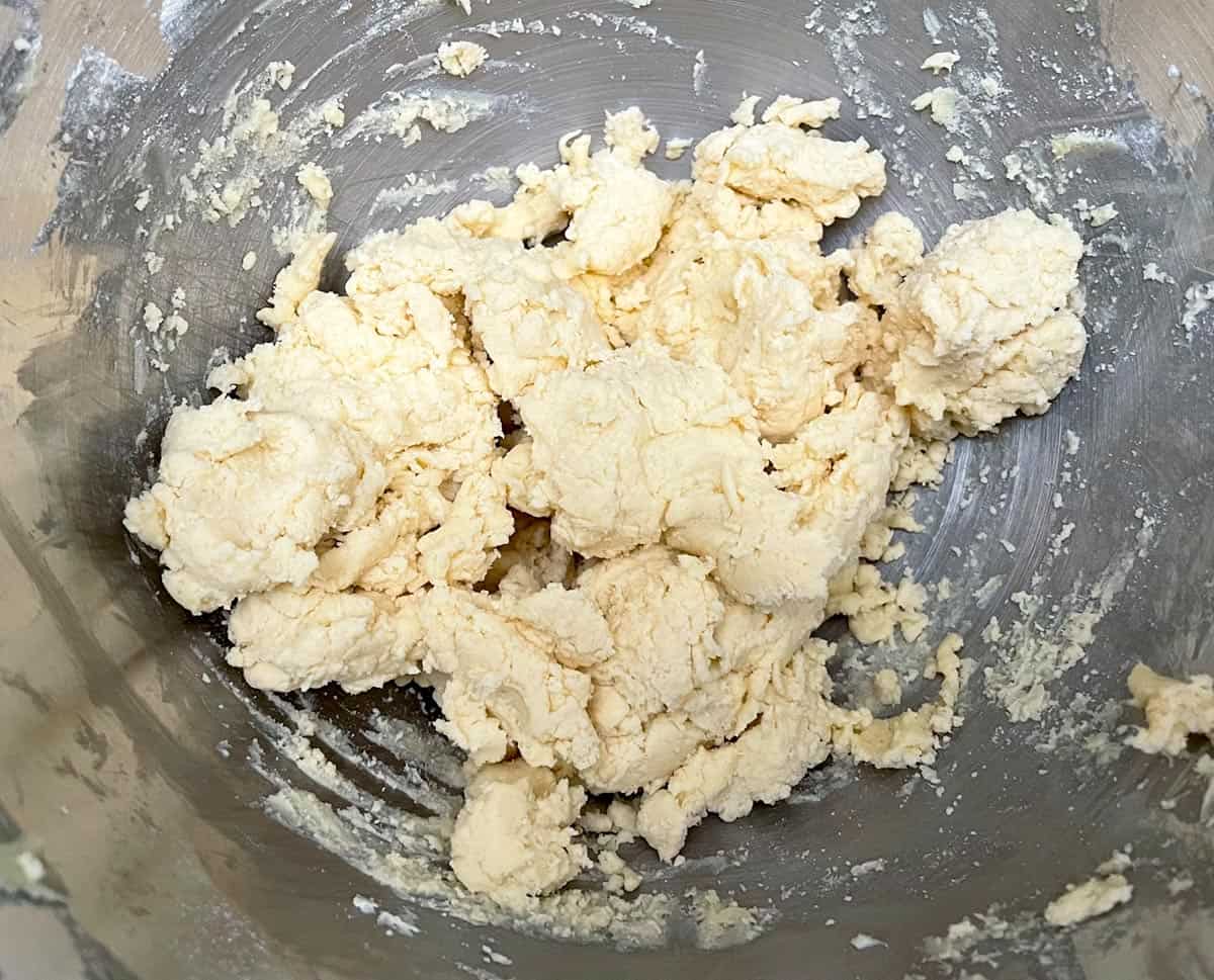 Shortbread dough in a mixer after all ingredients have been mixed.