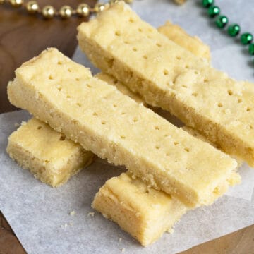 Buttery and crumbly Scottish shortbread cookies on parchment paper - feature image.