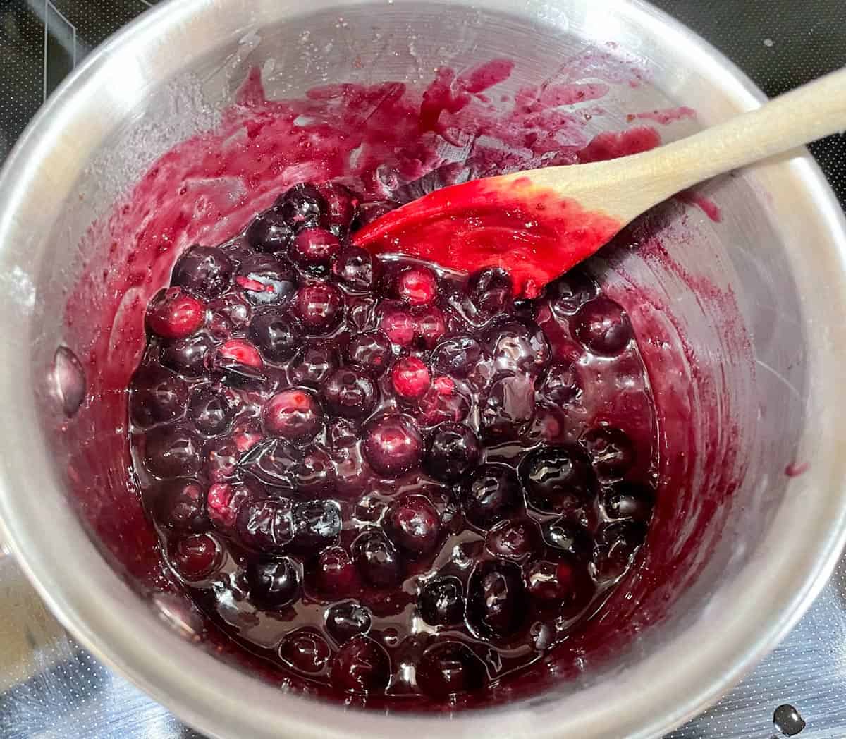 Cooking the blueberry topping.