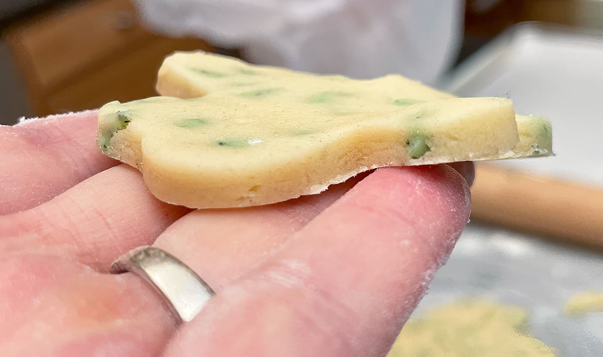 Shamrock shape cutout cookie showing how thick to roll your dough.