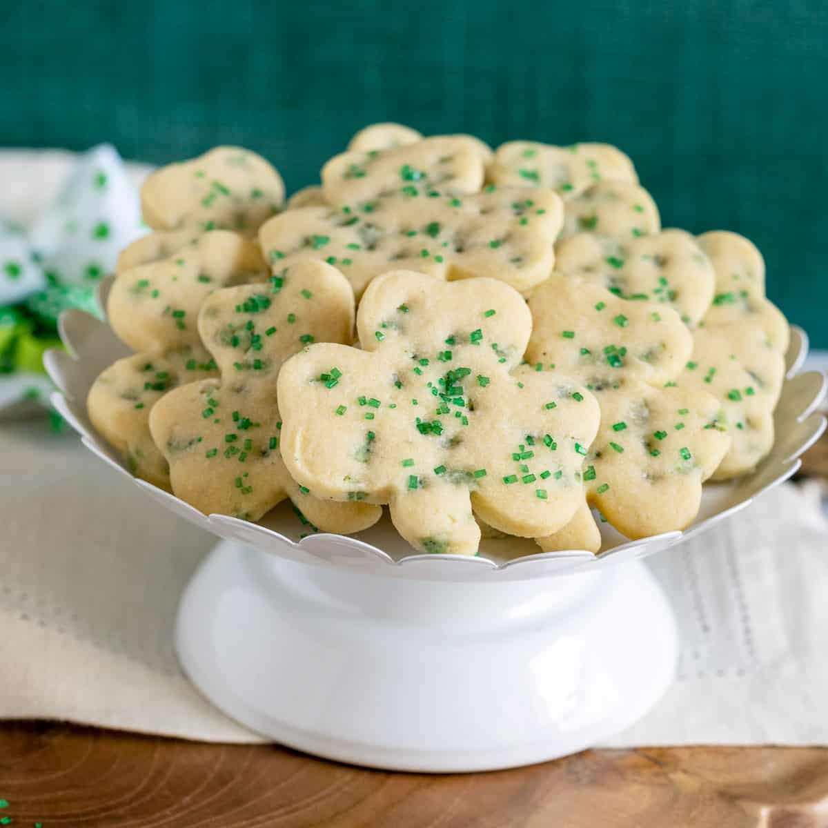 White bowl filled with mint chocolate shamrock cookies.