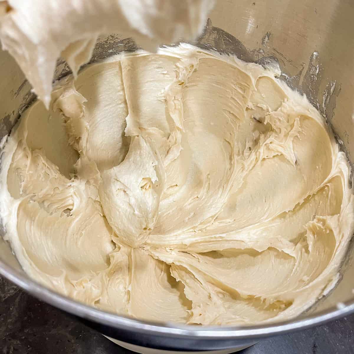 Mixer bowl with butter, sugars, and cream cheese looking really creamy after 3 minutes with the mixer.