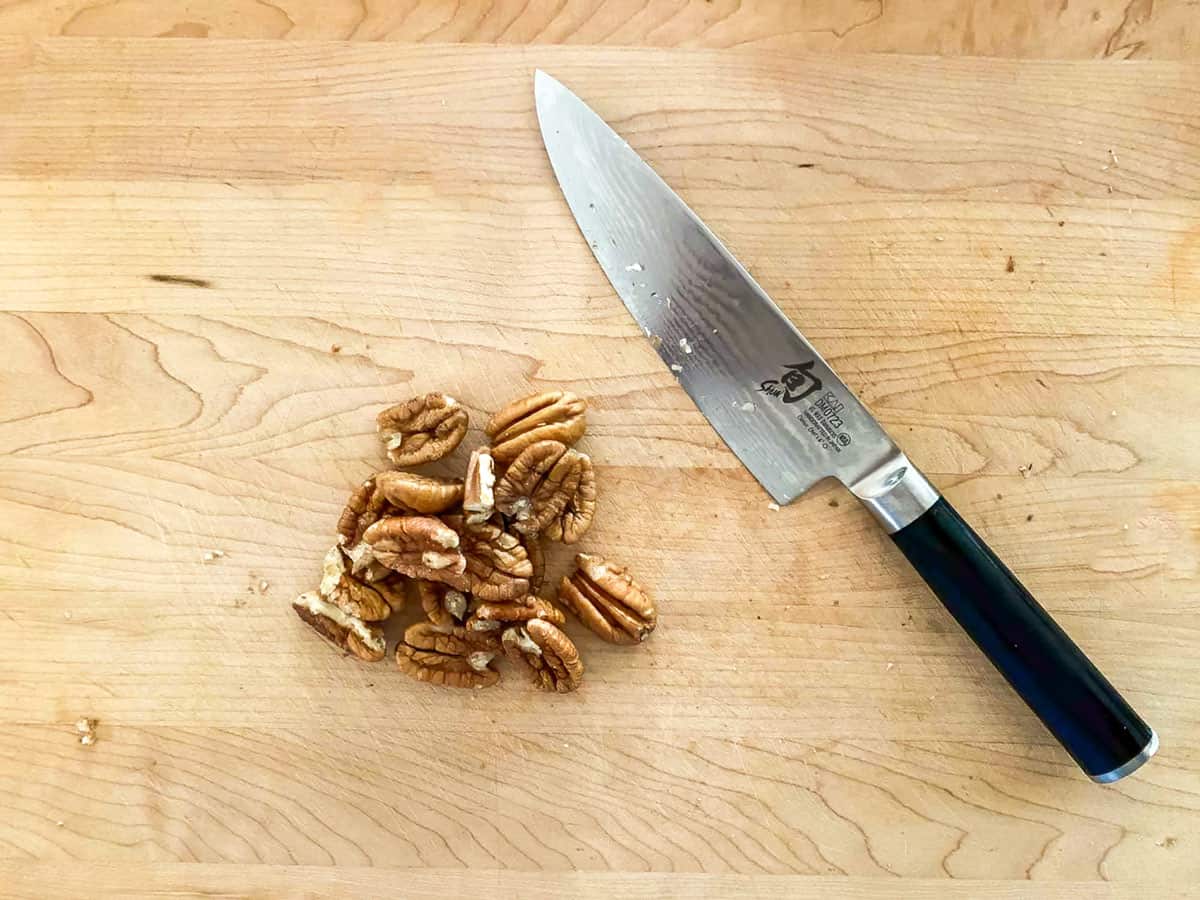 Chopping up pecans with a sharp knife.