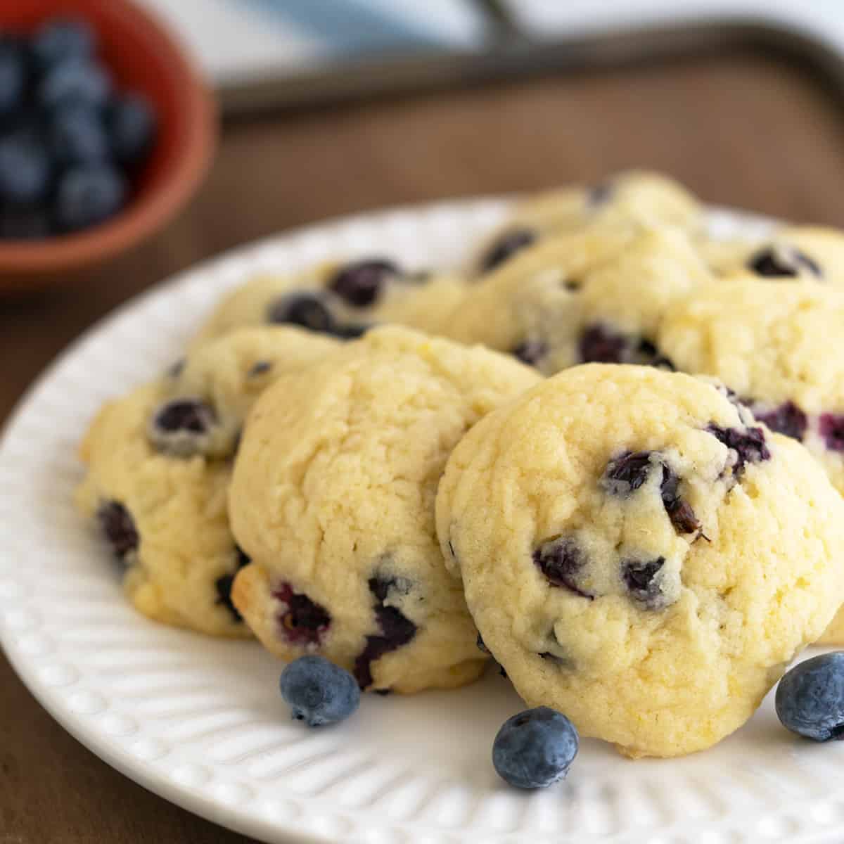 Fresh blueberry lemon maple cookies on a white plate.