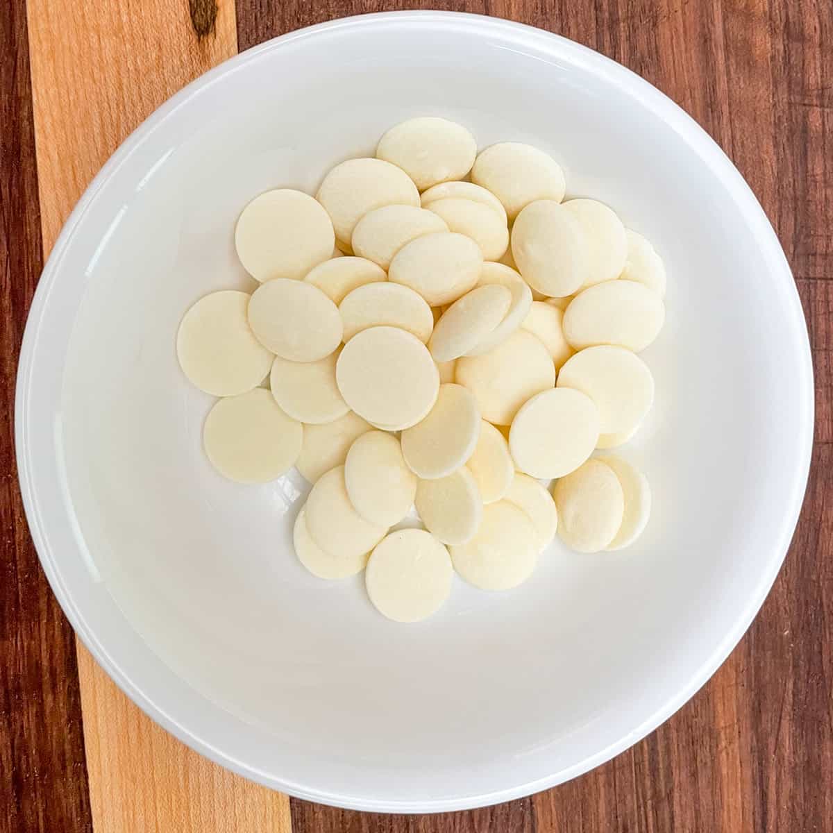 White chocolate wafers in a bowl.