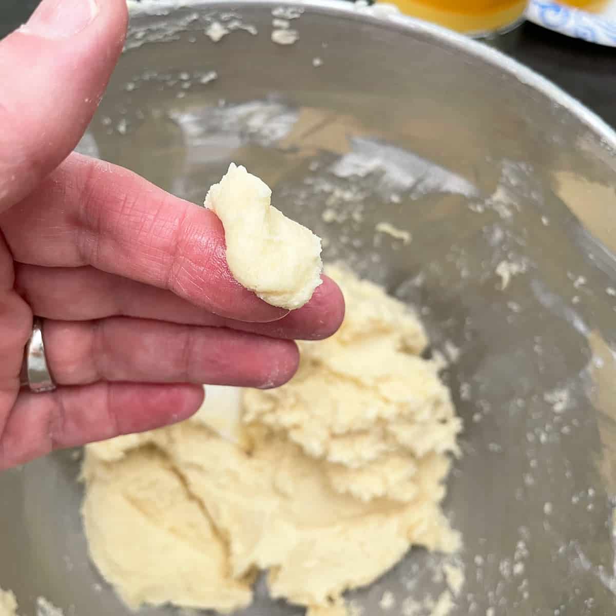 How the cookie dough should look if put between your fingers after the flour has been added.