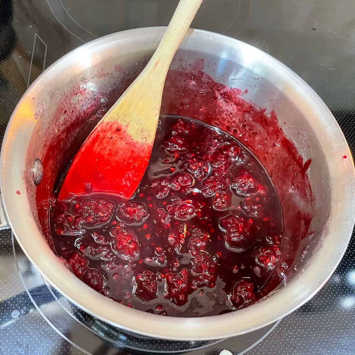 Blackberry, lemon, sugar and cornstarch heating in saucepan.