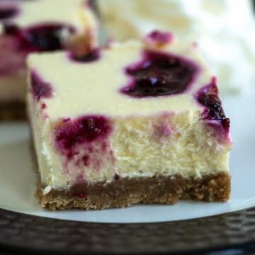 Side view of a blackberry lemon cheesecake bite.