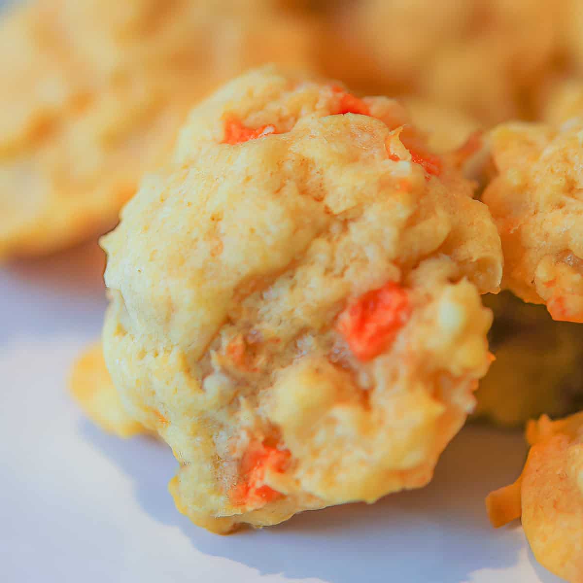 Baked Papaya Coconut and Macadamia nut cookies in a pile.