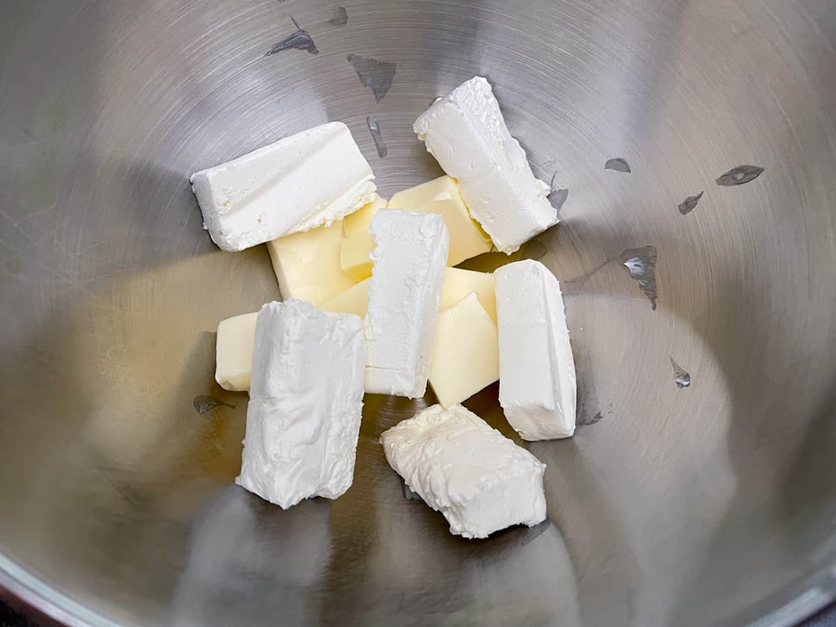 Cut up butter and cream cheese in a mixer bowl.